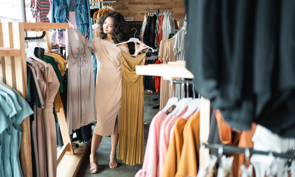 Woman shopping for sustainable clothing at an eco-friendly fashion boutique in the Coachella Valley.